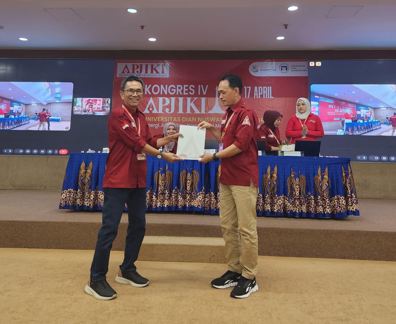 Ketua Umum APJIKI, Prof. Dr. Rajab Ritonga, menyerahkan laporan pertanggungjawaban Pengurus APJIKI Periode 2023-2026 kepada Pimpinan Sidang Kongres IV APJIKI, Dr. Edy Prihantoro. Foto; Indomaritim.com/RR