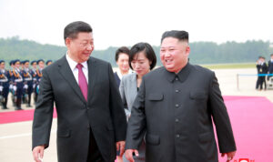 North Korean leader Kim Jong Un welcomes Chinese President Xi Jinping at the Pyongyang International Airport in Pyongyang