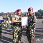 Panglima Korps Marinir (Pangkormar) Letnan Jenderal TNI (Mar) Endi Supardi memberi piagam penghargaan kepada salah satu prajurit Satgas Pengamanan Perbatasan (Pamtas) RI–PNG Mobile Yonif 10 Marinir di Lapangan Apel Brigif 1 Marinir, Kesatrian Marinir Hartono, Cilandak, Jakarta Selatan, Jumat (10/07/2026). Foto Antara