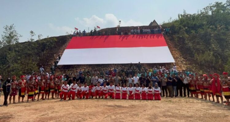 Participants unfold a giant Indonesian flag during an Independence Day parade in Jagoi Babang, Bengkayang District, West Kalimantan. Photo Source: Antara News Agency