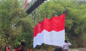 Sejumlah warga mengibarkan bendera merah putih berukuran 20x10 meter dalam rangka memperingati Hari Kemerdekaan ke-81 Republik Indonesia di Jembatan Sungai Citanduy perbatasan Kota Tasikmalaya dengan Kabupaten Ciamis, Jawa Barat, Senin (17/8/2026). Sumber foto: Antara