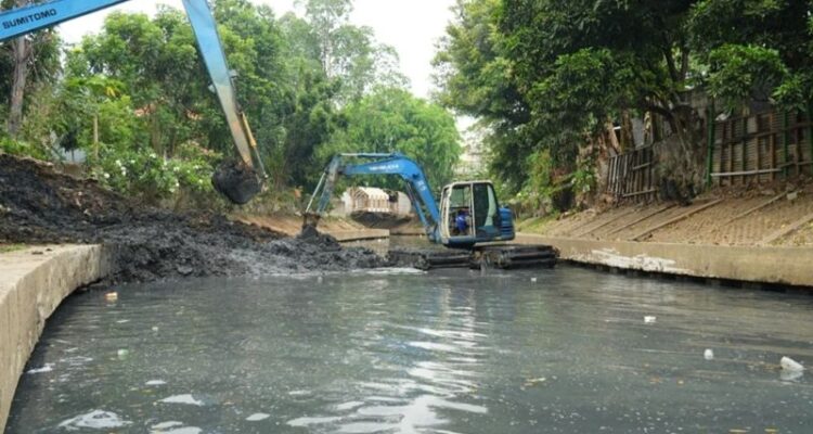 Alat berat Suku Dinas Sumber Daya Air (SDA) Jakarta Barat mengeruk sedimen lumpur di sepanjang sekitar tiga kilometer Kali Grogol, Kemanggisan sebagai upaya meningkatkan kapasitas tampungan air dan mengantisipasi banjir, Jumat (18/9/2026). Sumber foto: Antara