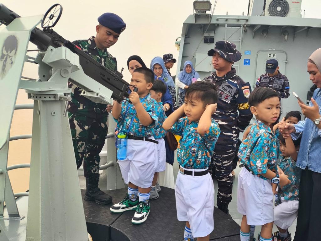 Anak buah KRI Karotang-872 memberi kesempatan kepada murid-murid TK untuk memegang senapan mesin ringan di kapal tersebut. Sumber foto: Dispen Kodaeral XII Anak buah KRI Karotang-872 memberi kesempatan kepada murid-murid TK untuk memegang senapan mesin ringan di kapal tersebut. Sumber foto: Dispen Kodaeral XII