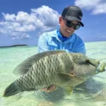 Ilustrasi - Seorang pemancing dengan ikan tangkapannya di Kepulauan Lucipara. Sumber foto: Adrees Expeditons