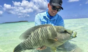 Ilustrasi - Seorang pemancing dengan ikan tangkapannya di Kepulauan Lucipara. Sumber foto: Adrees Expeditons